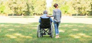 Senior in Chair Accompanied by woman