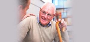 Elderly Man being comforted by individual