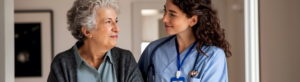 Photo of a young caregiver helping senior woman walking.